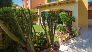 A residential building with a garden featuring cacti and potted plants. - Sunwing Beach by Interhome (Port d'Alcúdia)