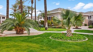 A residential area with palm trees, a well-maintained lawn, and houses with a similar architectural style. - SWSS 3BR Kierland Greens Condo | Pool, Hot Tub, Golf Access & Gated Community (Scottsdale)