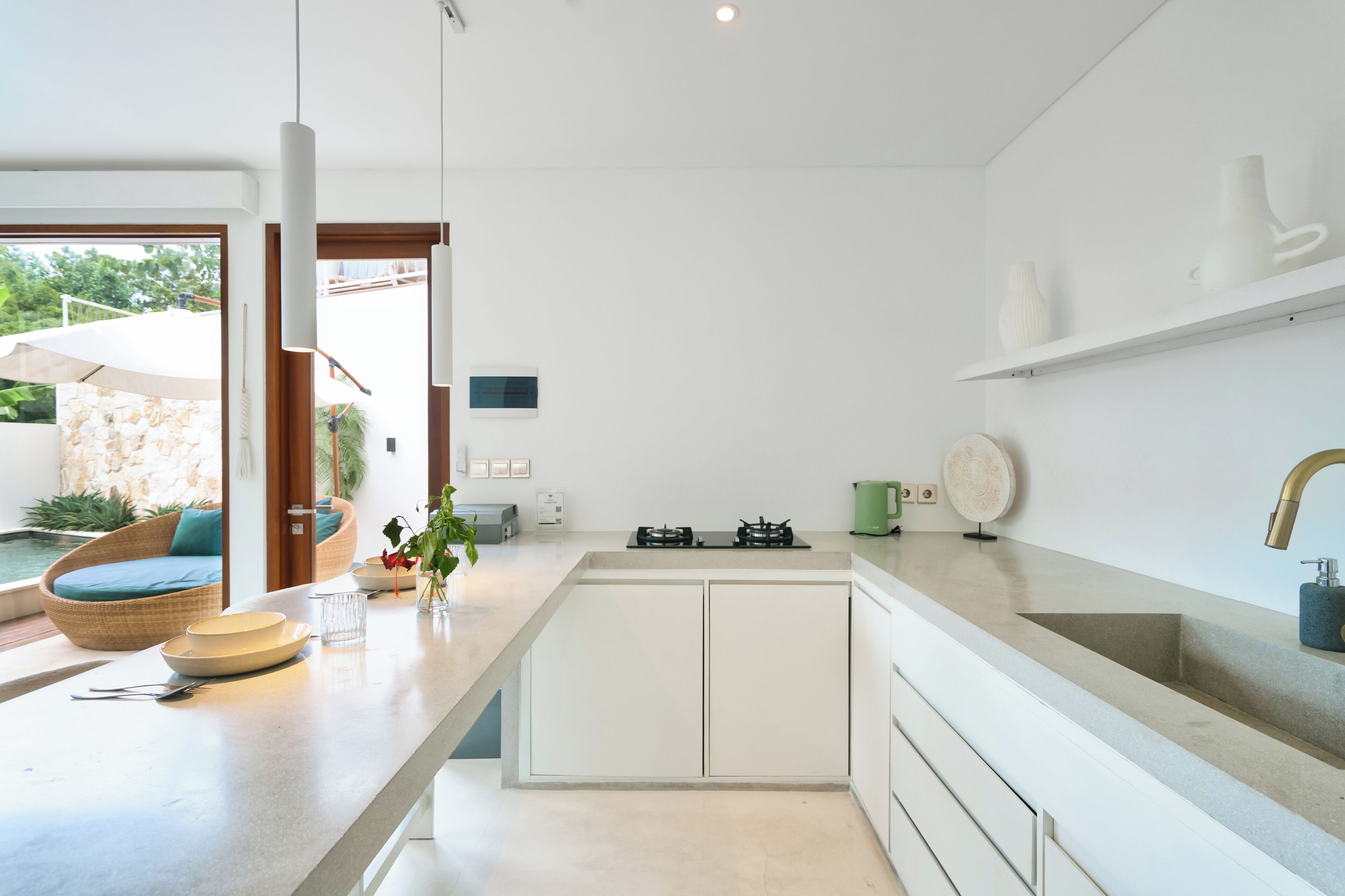 A modern kitchen with white cabinetry, a gas stove, and a large island with seating.