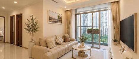 Design Apartment, 3 Bedrooms | Living area | 45-inch flat-screen TV with digital channels, fireplace, offices