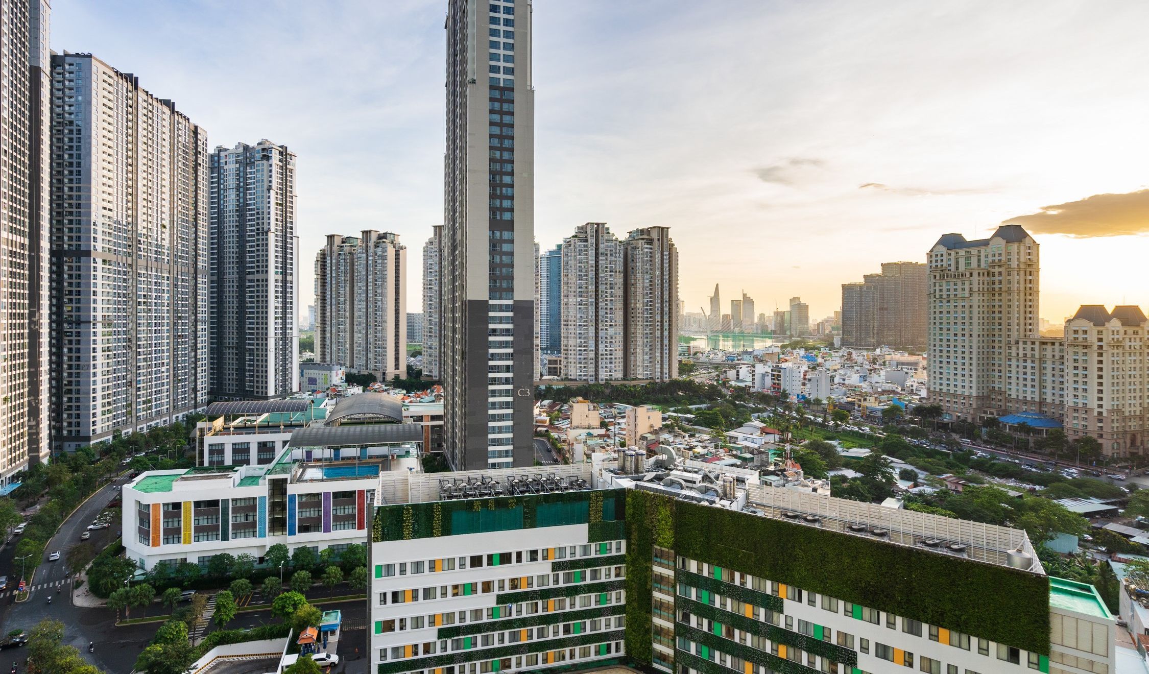 A high-rise building with a modern design, surrounded by other tall residential buildings.