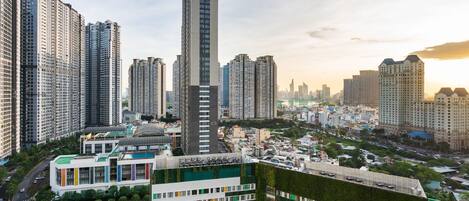 A high-rise building with a modern design, surrounded by other tall residential buildings.