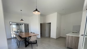 A modern kitchen with a wooden countertop and a sink. - Caballito Retreat Rooftop Pool and Balcony (Buenos Aires)