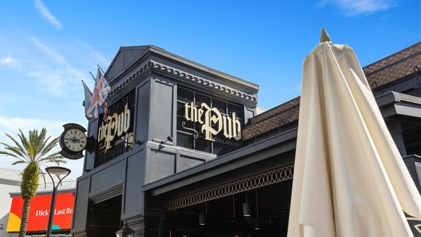 A building with a sign reading "the Pub" and a clock on the left. - Vor4863pp: 6 Bed, Gamer's Paradise, Gaming Loft (Orlando)