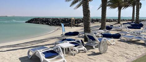 On the beach, sun-loungers, beach towels