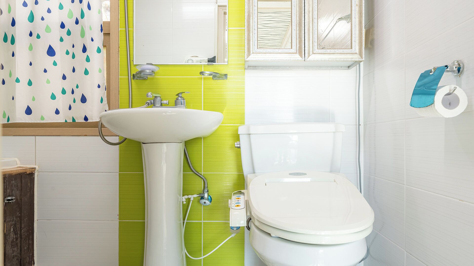 A bathroom with a white sink, a toilet, and a shower.