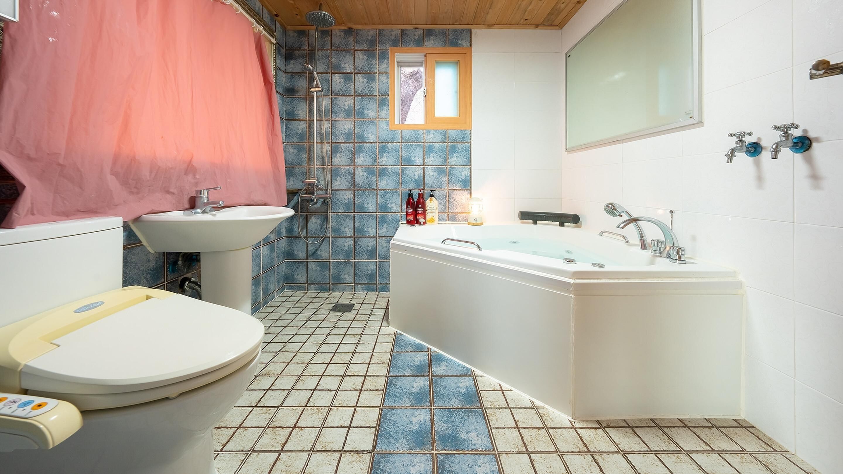 A bathroom with a toilet, sink, shower, and bathtub.