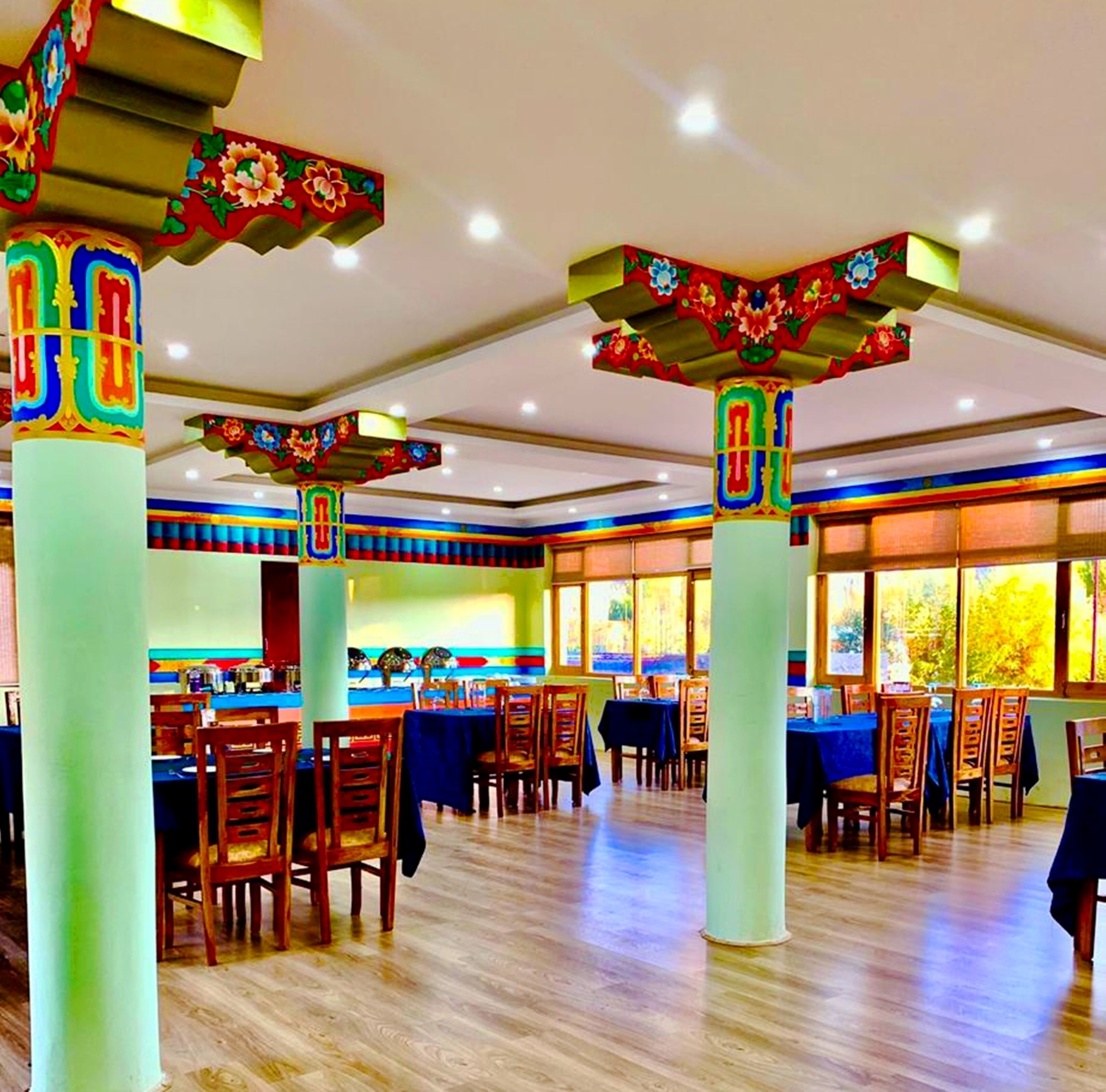 A restaurant with colorful pillars and tables.