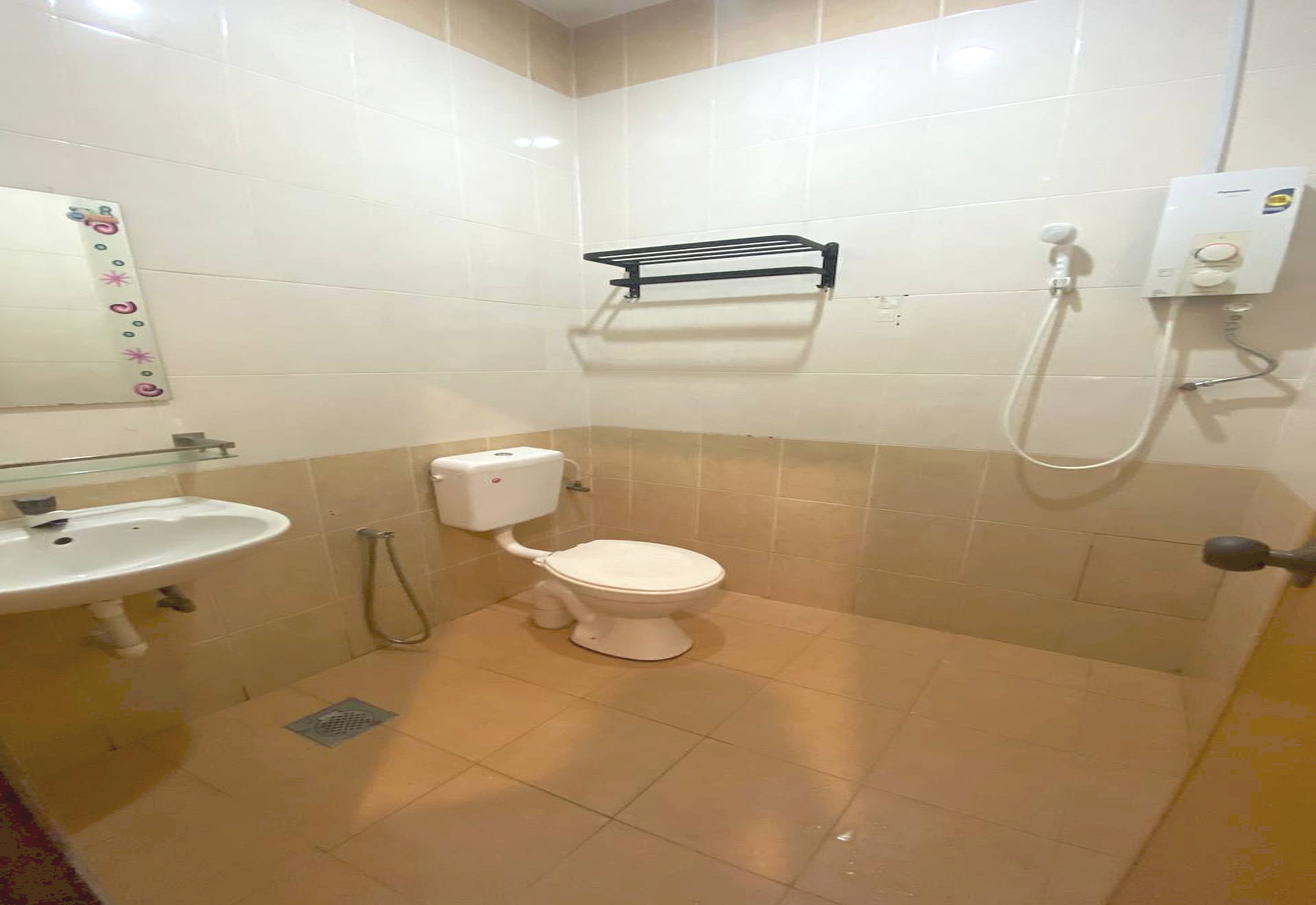 A bathroom with a toilet, sink, and shower.