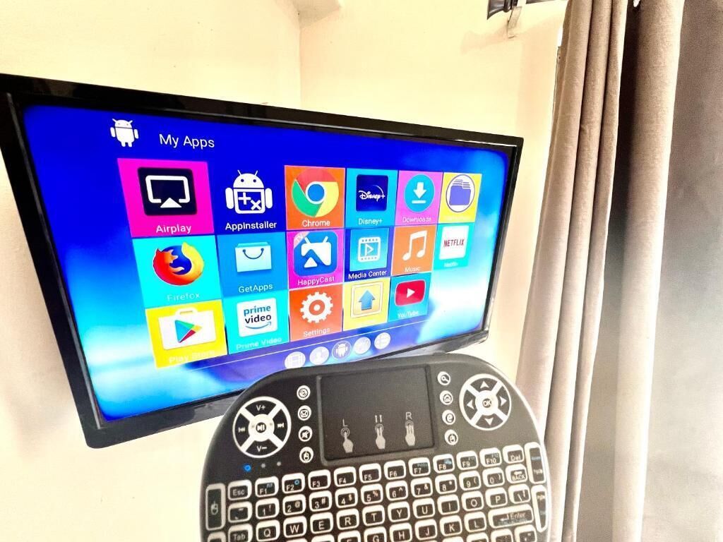 A tablet displaying a variety of app icons, including Airplay, Appinstaller, Chrome, and Netflix.