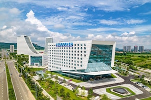A modern hotel with a unique architectural design, featuring a large glass facade and a distinctive geometric structure.