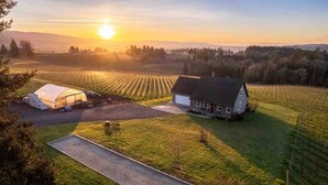 A rural landscape with a house and greenhouse. - Picturesque Vineyard and Valley Views, Quiet and Private Setting, Huge Deck, *Complimentary Wine* (Newberg)