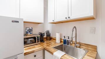 Fridge, microwave, coffee/tea maker, cookware/dishes/utensils