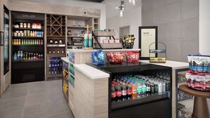 A modern retail store with a chilled section, a variety of snacks, and a selection of beverages.