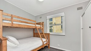 Habitación con literas, una ventana y una puerta.