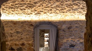 A stone-walled pool area with a clear blue pool, a towel, and a crab decoration. - YeeOn Boutique Hotel, Gythio - Historic Hotels of Europe (East Mani)