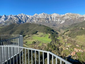 Un paysage montagneux offrant une vue sur une vallée et un petit village.