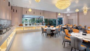 A modern dining area with a buffet, multiple tables, and chairs. - Days Inn by Wyndham Kunming Airport Economic Zone (Kunming)