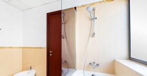 A bathroom with a shower, a sink, and a window. - LUX The JBR BlueWaters View Suite 2 (Dubai)
