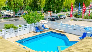 A swimming pool with blue tiles, white fence, and lounge chairs. - Simple Hotel Hersonissos Sun (Hersonissos)