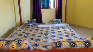 A hotel room with a bed, curtains, and a window. - 020-22Airbnbs (Thika)