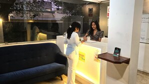 A reception desk with a sign for 'Jungle' and a small shelf with a card. - Jungle by sturmfrei Vagator (Vagator)