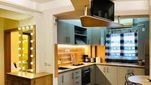 A compact kitchen with a vanity, sink, and a television above the counter. - Joy City Stay Victoriei 7G-3 (Timișoara)