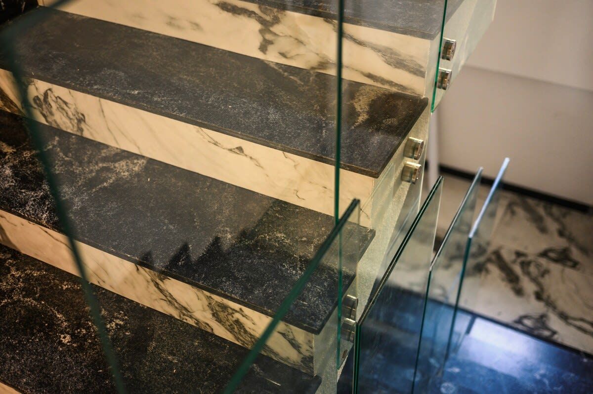 A glass railing with a marble-like pattern.