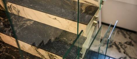 A glass railing with a marble-like pattern.