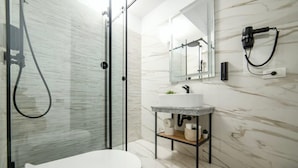 A modern bathroom with a glass shower enclosure, a white toilet, a marble sink, and a mirror above the sink. - GBU Home Azure Room 301 (Timișoara)