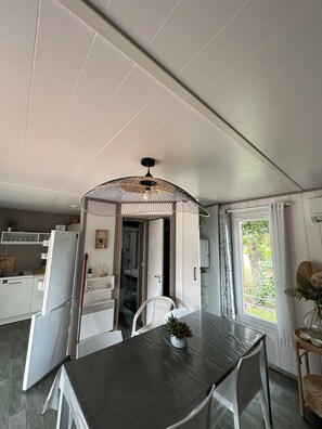 Enjoy meals in this stylish dining area with a large table and pendant light.