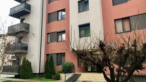 A multi-story residential building with balconies, a staircase, and a small garden area. - Joy City Stay Martirilor Giroc 4 (Timișoara)