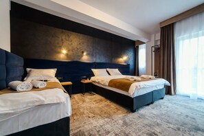 A hotel room with two beds, a large dark headboard, and a view of the outdoors. - GBU Home  Olive Executive 403 (Timișoara)