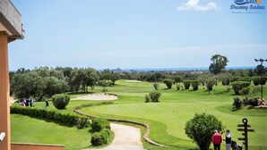 A golf course with a clear path leading to the tee area, surrounded by lush greenery and trees. - Beachfront vacation home in elegant residential complex near Chia (Pula)