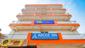 A multi-story building with a prominent 'fab hotels' sign and an 'abode inn' sign. - Fabexpress Abode Inn (New Delhi)