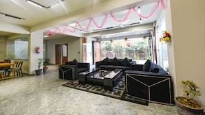 A modern living room with a sofa set, a coffee table, and a patterned rug. - Fabhotel Naina Residency (Rishikesh)