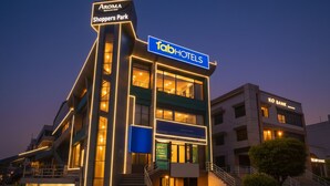 A modern hotel with a prominent 'Tab Hotels' sign, multiple floors, and a well-lit facade. - Fabhotel Ip Indrapuram (Ghaziabad)