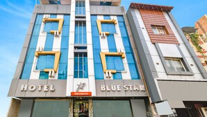A hotel named 'Blue Star' with a modern design, featuring large windows and a prominent 'HOTEL' sign. - Fabexpress Blue Star (Ujjain)