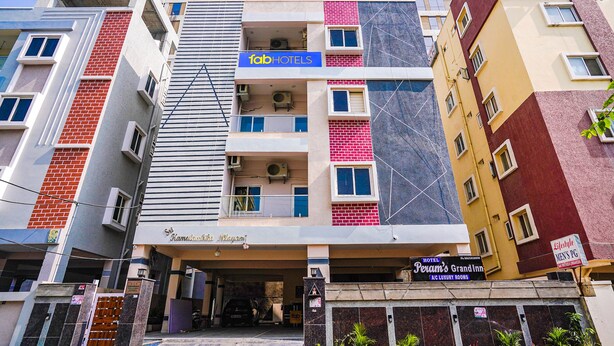 A multi-story hotel with a modern facade, including a prominent 'fabHOTELS' sign and a 'Hotel Peam's Grand Inn' sign. - Fabhotel Perams Grand Inn (Hyderabad)