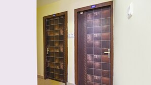Two doors with number plates, one labeled 302 and the other 303, in a hallway with tiled flooring. - Fabexpress Rs Villa (Barasat)