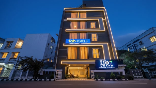 A modern hotel building with a prominent 'fabHOTELS' sign, a large entrance, and a 'HOTEL LION 7 GRAND' sign. - Fabhotel Lio7 Grand (Hyderabad)