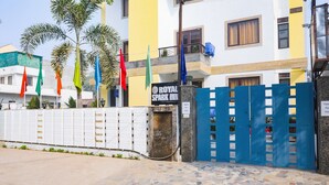A hotel entrance with a sign reading "ROYAL SPARK INN" and a blue gate. - FabHotel The Indian (Gurugram)