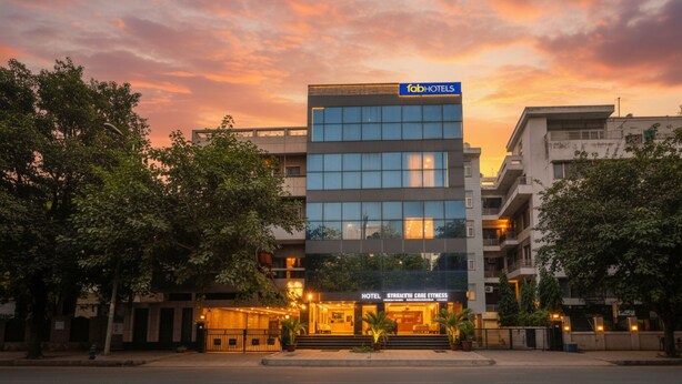 A modern hotel building with a sign for 'fabHOTELS' and 'HOTEL STRAMMI LOBE FITNESS'. - FabHotel Nirvana Residency (New Delhi)