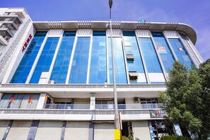 A modern building with large glass windows and a sign that reads "Westin Look". - Fabhotel 7 Star (Surat)