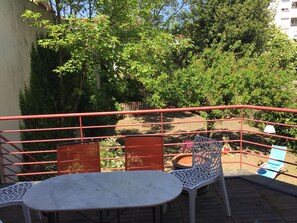 Sit and enjoy the view from this outdoor seating area with a table and two chairs.