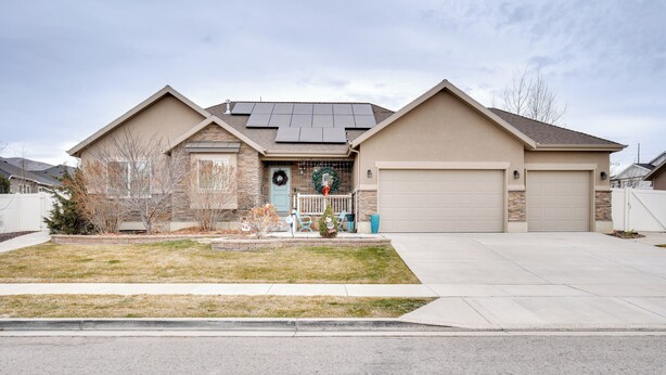 A two-story house with a garage, solar panels, and a front porch with a Christmas wreath. - Modern Lehi Apartment: 2 Mi to Thanksgiving Point (Lehi)
