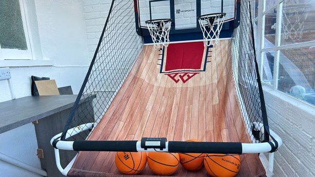 A basketball hoop with three basketballs and a red backboard. - Cool 2 Bed House Hornchurch, Arcade Games, Parking (Hornchurch)