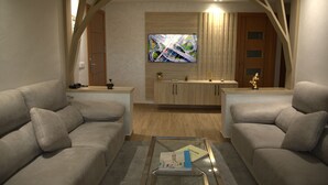 Un salon moderne comprenant deux canapés, une table basse, un téléviseur et un meuble en bois.