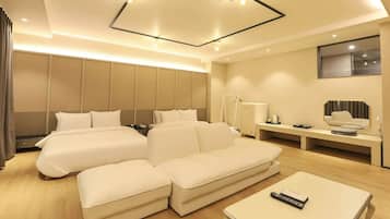Relax in this stylish room with a large L-shaped bed and two sofas, perfect for unwinding.