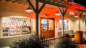 A country store with a sign reading "Millstone Country Store" and "OPEN" sign above the entrance. - Cozy Lake Front Park Model on Douglas Lake with Hot Tub! (Dandridge)